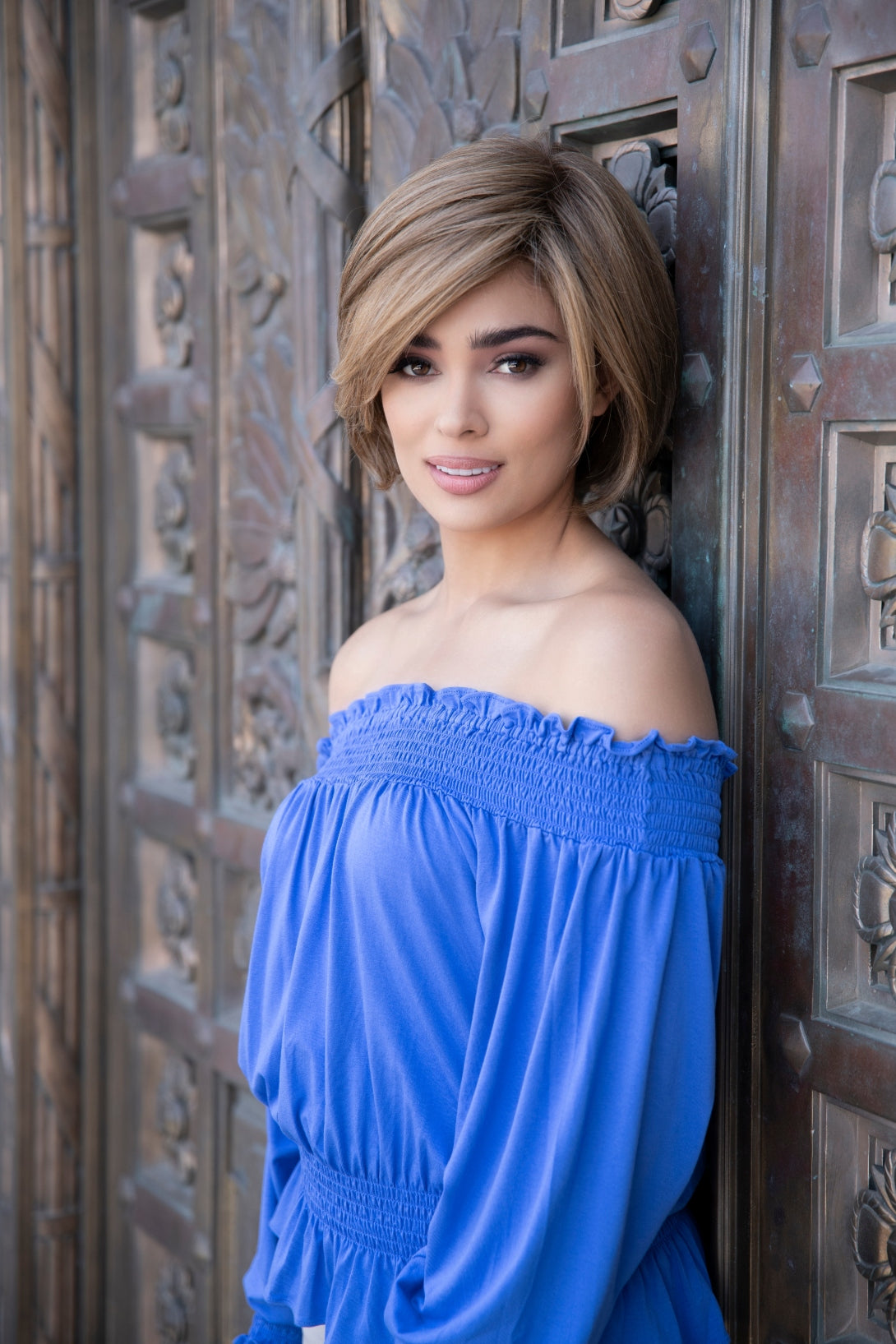 front side of a short Kinner Beauty Wigs wig on woman head