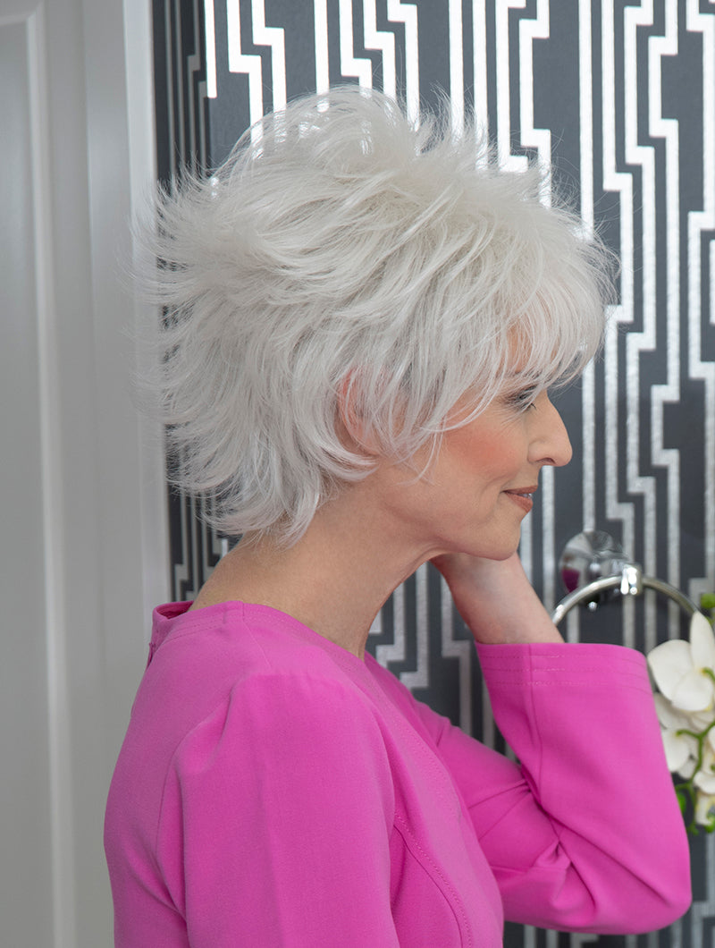 profile side of a short Kinner Beauty Wigs wig on woman head