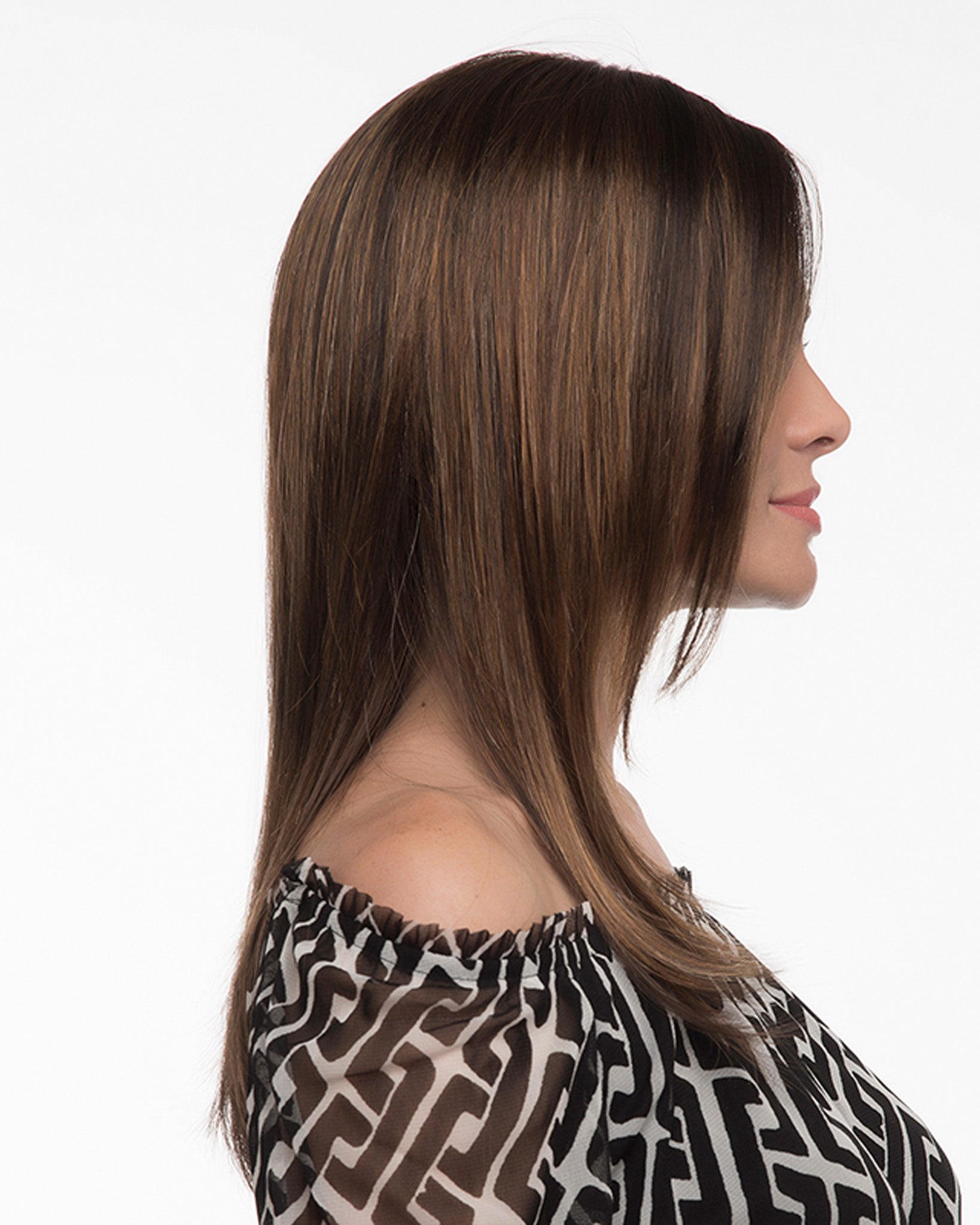profile side of a long Kinner Beauty Wigs wig on woman head