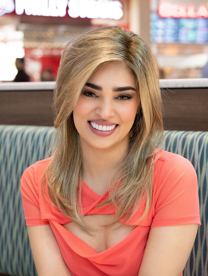 front side of a long Kinner Beauty Wigs wig on woman head