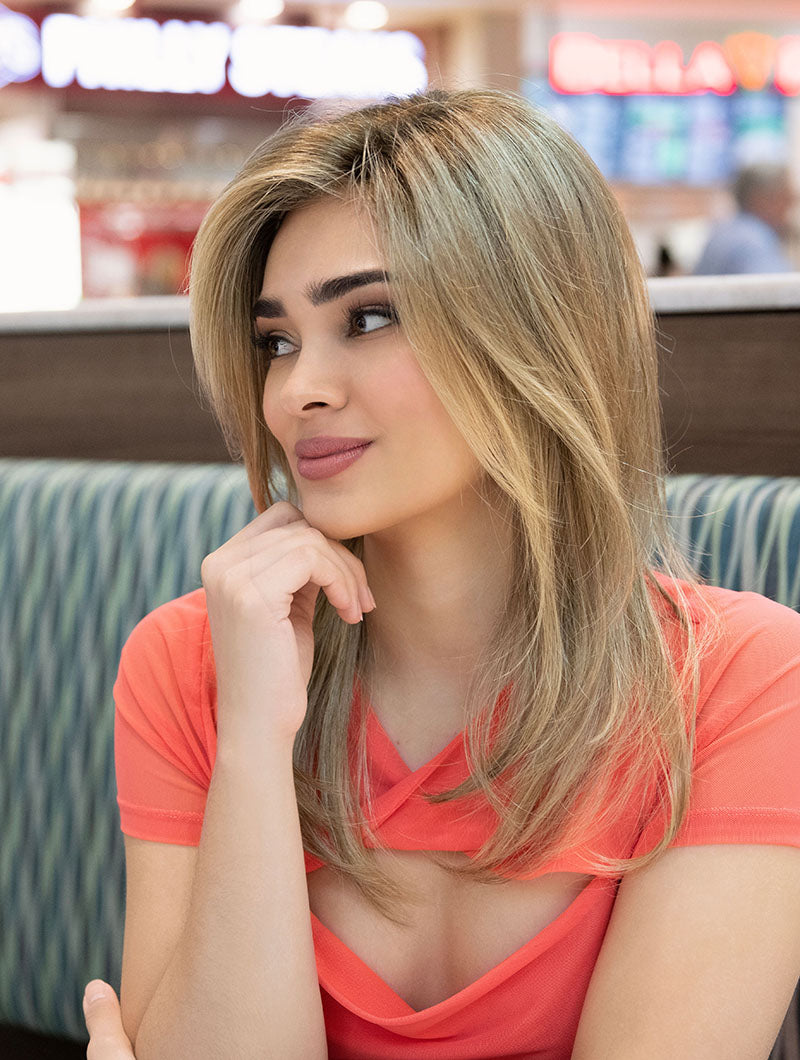 profile side of a long Kinner Beauty Wigs wig on woman head