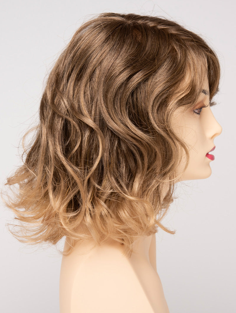 profile side of a medium Kinner Beauty Wigs wig for woman on mannequin head