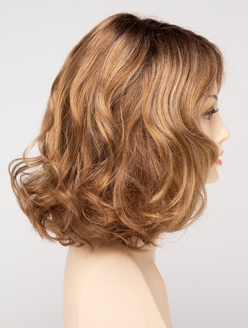 profile side of a medium Kinner Beauty Wigs wig for woman on mannequin head