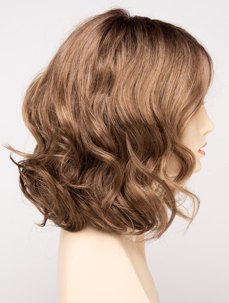 profile side of a medium Kinner Beauty Wigs wig for woman on mannequin head