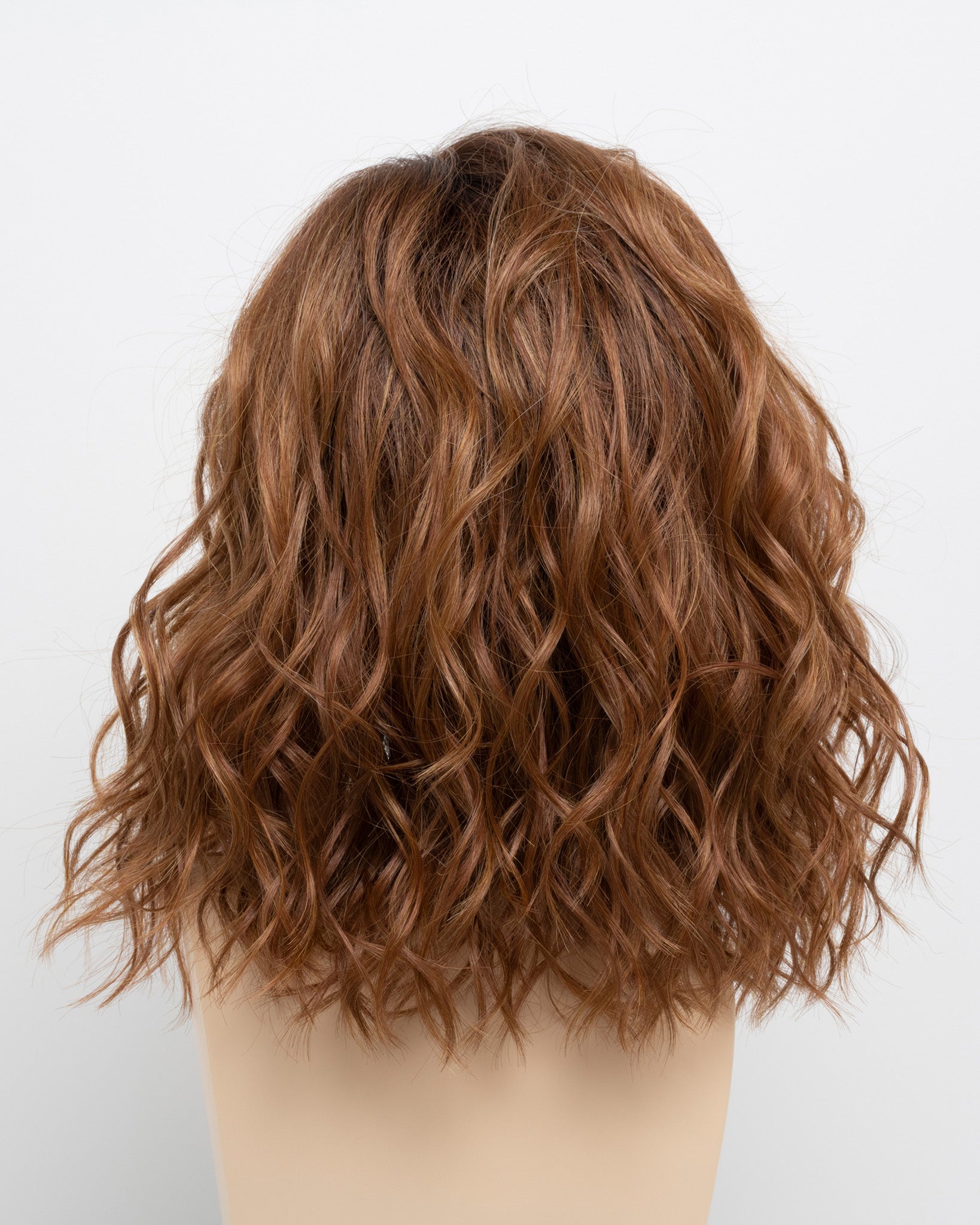 back side of a medium Kinner Beauty Wigs wig for woman on mannequin head