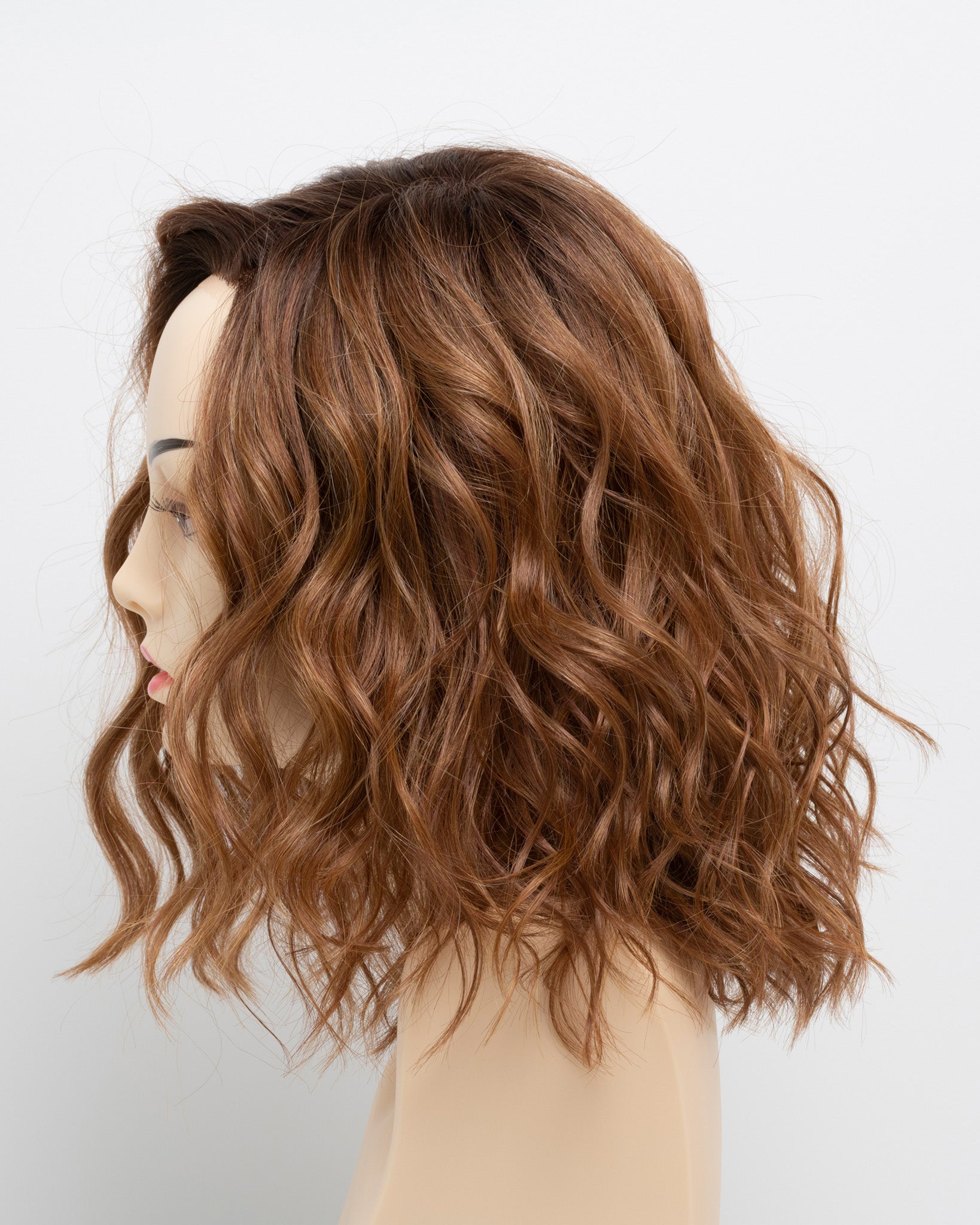 profile side of a medium Kinner Beauty Wigs wig for woman on mannequin head