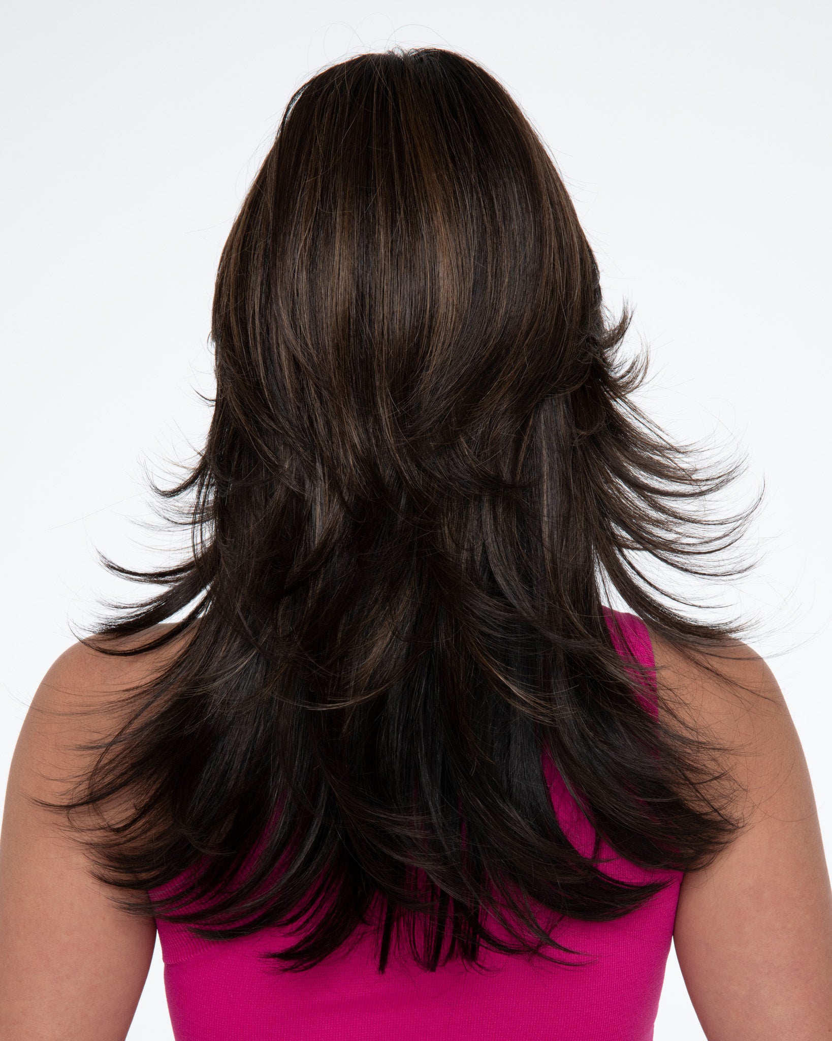 back side of a long Kinner Beauty Wigs wig on woman head