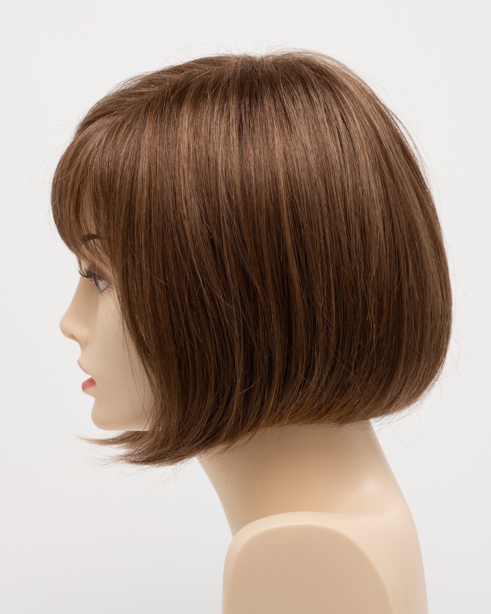 profile side of a short Kinner Beauty Wigs wig on woman head