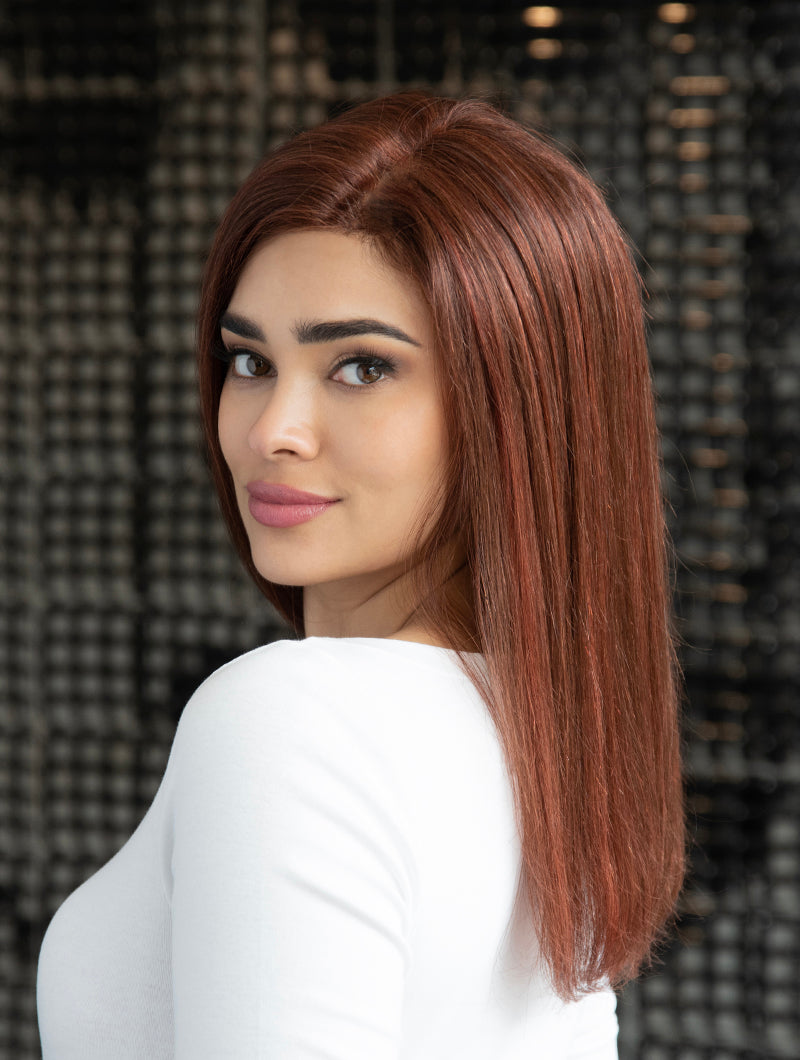 profile side of a long Kinner Beauty Wigs wig on woman head