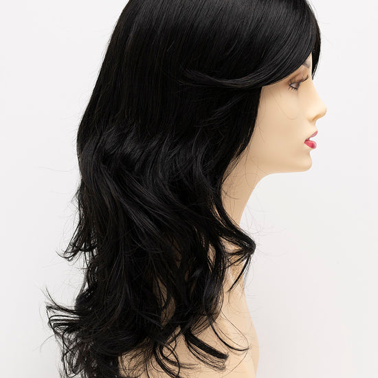 profile side of a long Kinner Beauty Wigs wig for woman on mannequin head 