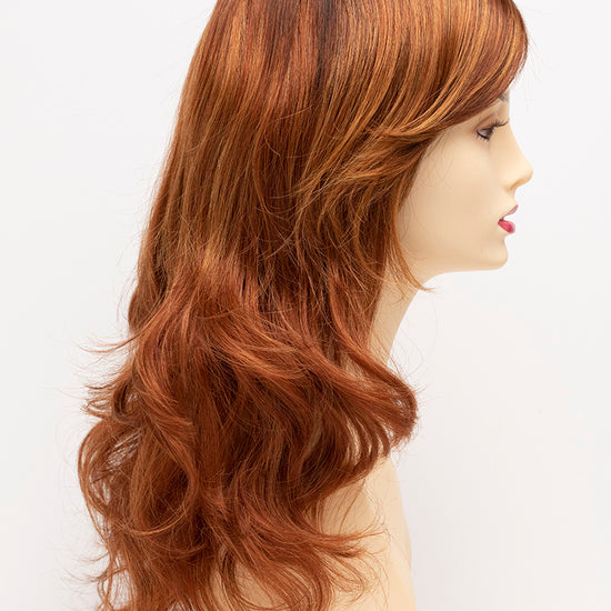 profile side of a long Kinner Beauty Wigs wig for woman on mannequin head 