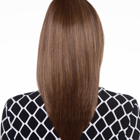 back side of a long Kinner Beauty Wigs wig on woman head 