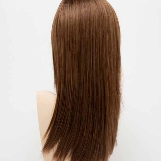 back side of a long Kinner Beauty Wigs wig for woman on mannequin head 