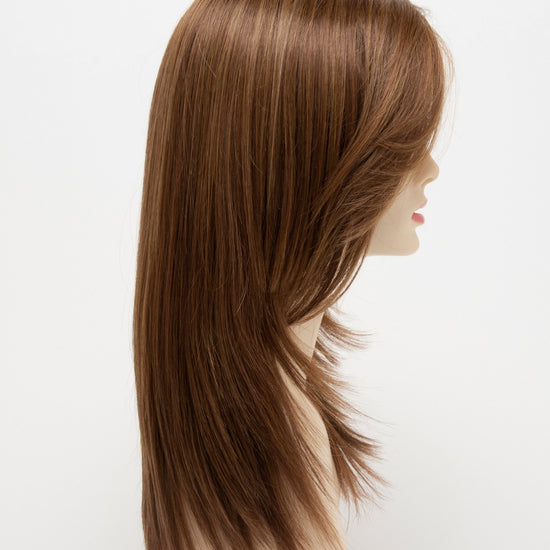 profile side of a long Kinner Beauty Wigs wig for woman on mannequin head 