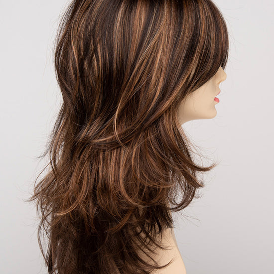 profile side of a long Kinner Beauty Wigs wig for woman on mannequin head 