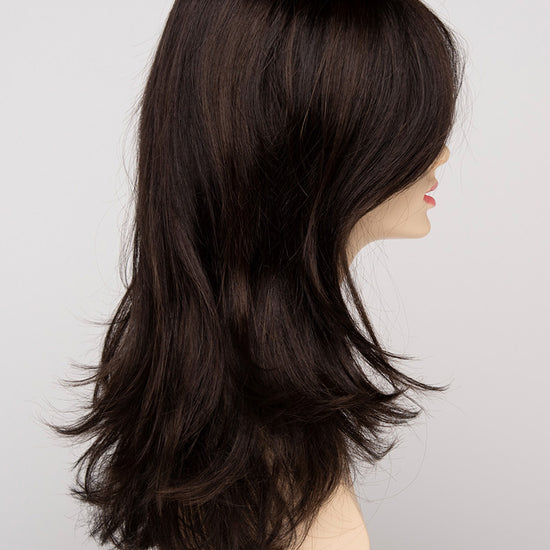 profile side of a long Kinner Beauty Wigs wig for woman on mannequin head 