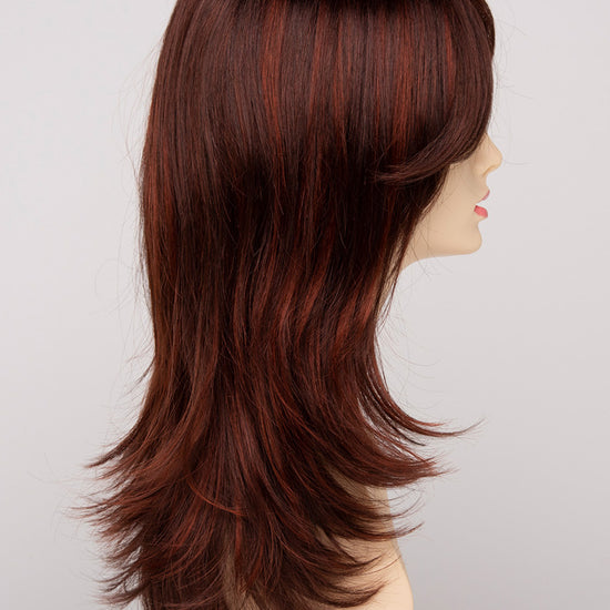 profile side of a long Kinner Beauty Wigs wig for woman on mannequin head 