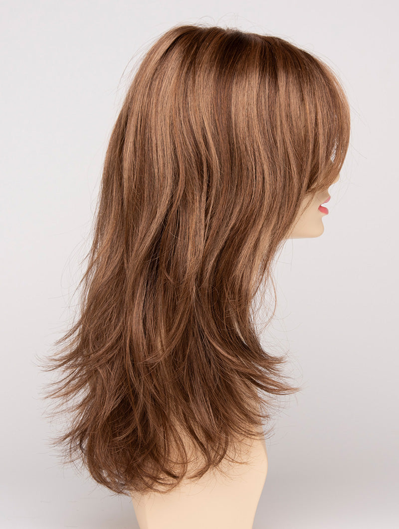 profile side of a long Kinner Beauty Wigs wig for woman on mannequin head 