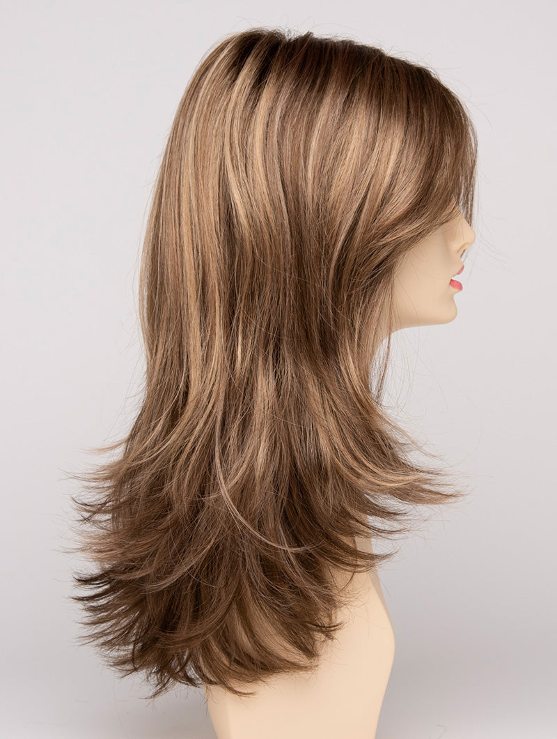 profile side of a long Kinner Beauty Wigs wig for woman on mannequin head 