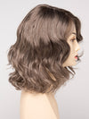 profile side of a medium Kinner Beauty Wigs wig for woman on mannequin head 