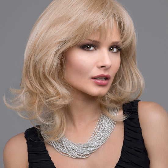 front side of a medium Kinner Beauty Wigs wig on woman head 