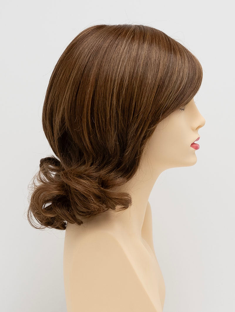 profile side of a medium Kinner Beauty Wigs wig for woman on mannequin head 