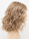 profile side of a medium Kinner Beauty Wigs wig for woman on mannequin head 