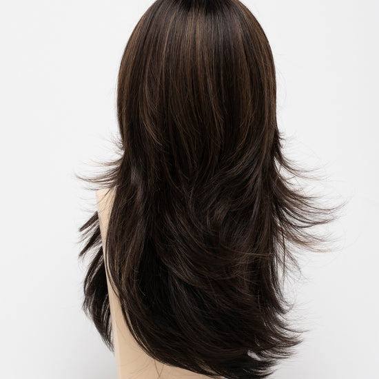 back side of a long Kinner Beauty Wigs wig for woman on mannequin head 
