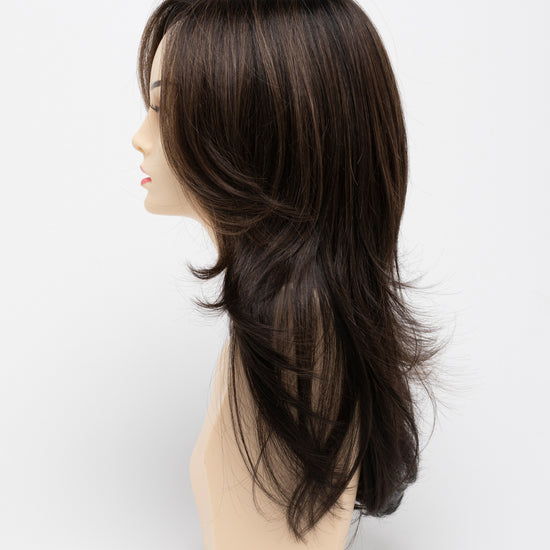profile side of a long Kinner Beauty Wigs wig for woman on mannequin head 