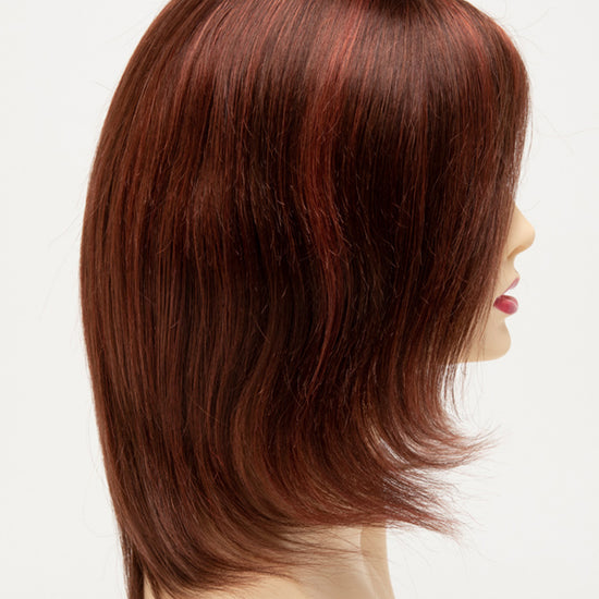 profile side of a medium Kinner Beauty Wigs wig for woman on mannequin head 