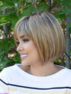 profile side of a short Kinner Beauty Wigs wig on woman head 