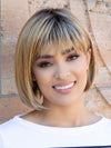 front side of a short Kinner Beauty Wigs wig on woman head 