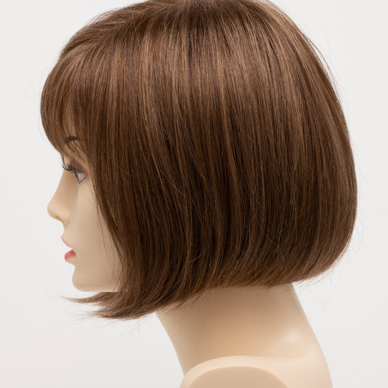 profile side of a short Kinner Beauty Wigs wig on woman head 