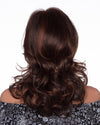 back side of a long Kinner Beauty Wigs wig on woman head 