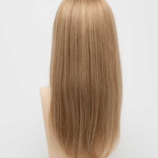 back side of a long Kinner Beauty Wigs wig for woman on mannequin head 