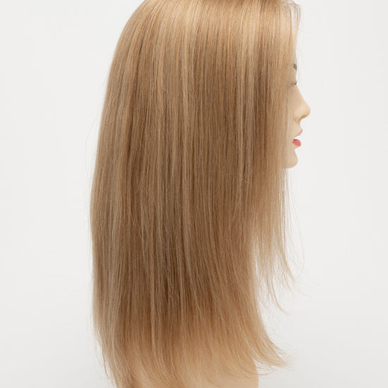 profile side of a long Kinner Beauty Wigs wig for woman on mannequin head 